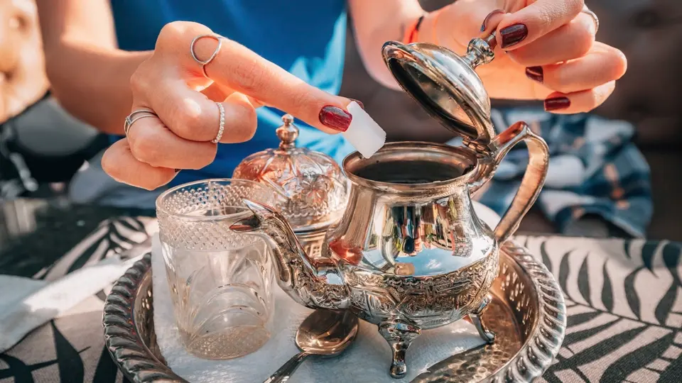 Adding sugar to teapot